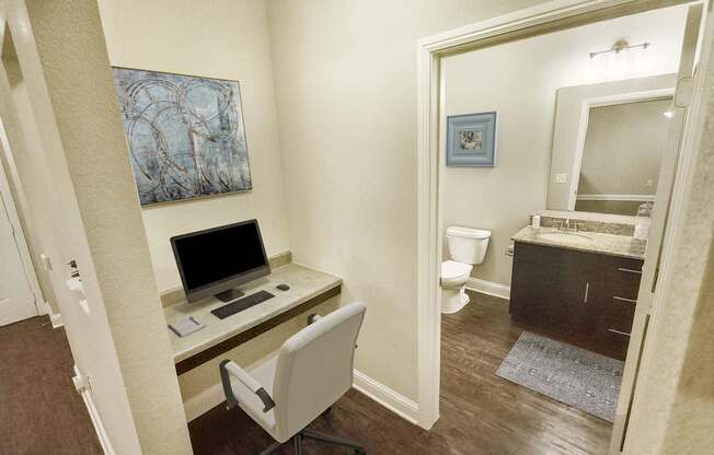 A room with a desk and a chair.