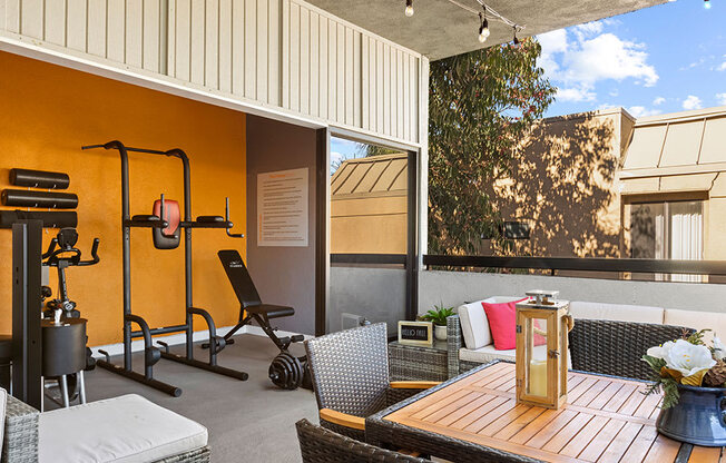 On-site fitness center with weight equipment and view of lounge.