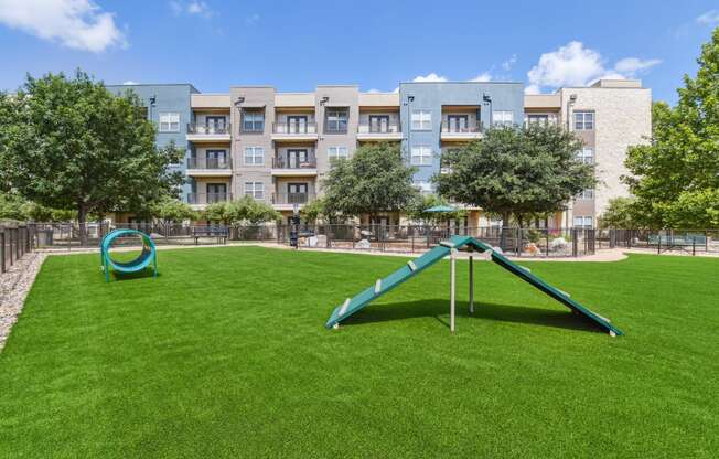 a swing set in the middle of a lush green park