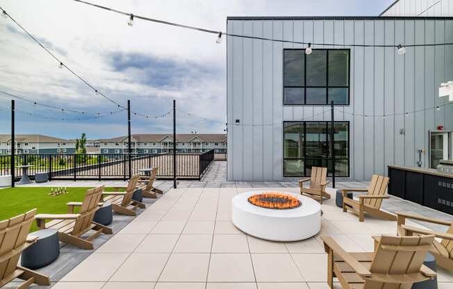 a patio with wooden chairs and a fire pit at The Standard on 32nd, West Fargo, 58078