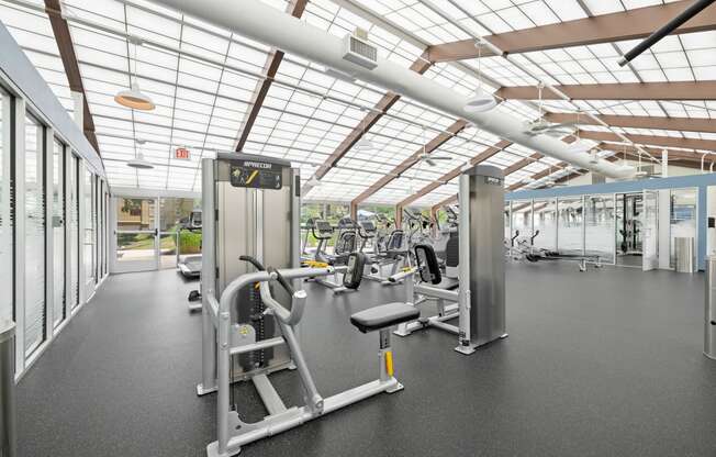 a gym with weights and cardio equipment and glass ceilings