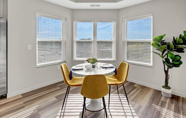 an image of a dining room with a table and chairs