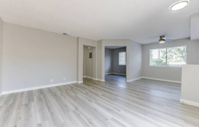 an empty living room with a large window