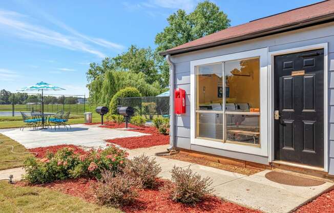 the guest house has a patio and backyard with a grill and umbrella