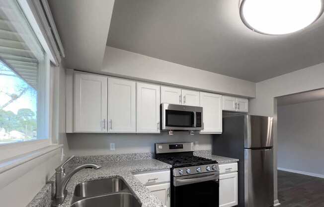 a kitchen with granite counter tops and stainless steel appliances