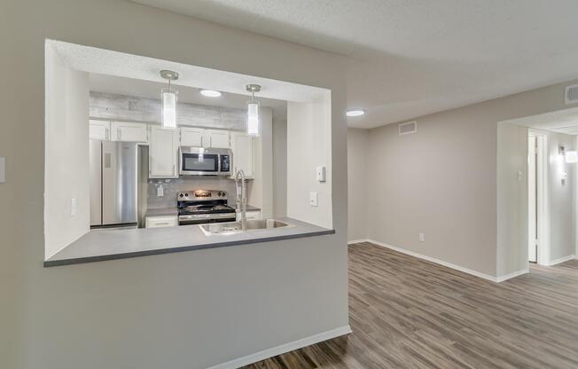 a kitchen with a sink and a mirror