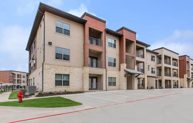 Apartment complex with a red fire hydrant in front.
