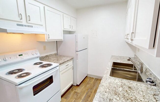 a kitchen with white appliances and white cabinets