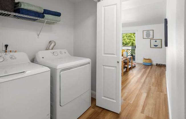 A small laundry room with a washer and dryer.
