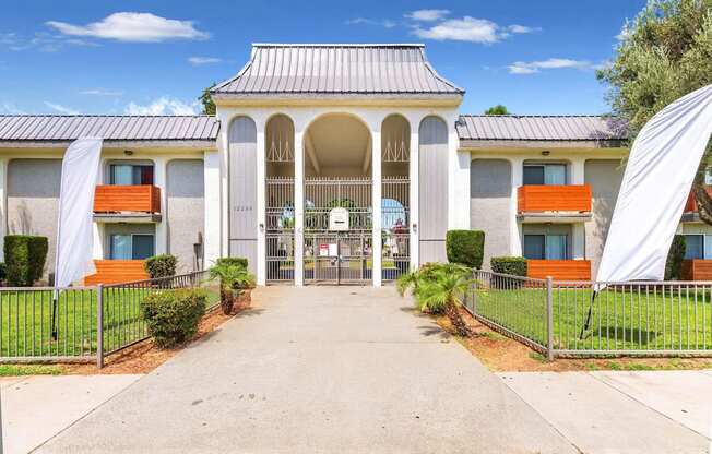 a white building with a walkway and a gate at Sunnymead Apts Apartments, California
