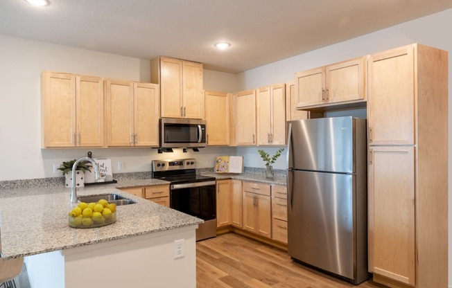 a kitchen with stainless steel appliances and granite counter tops