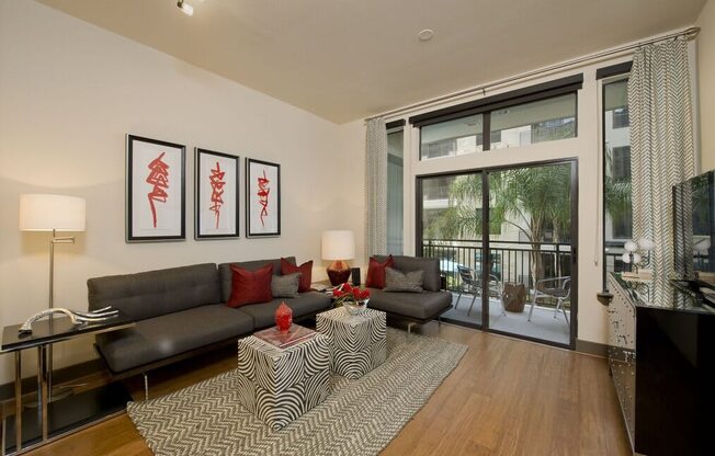 a living room with a leather couch and a zebra rug