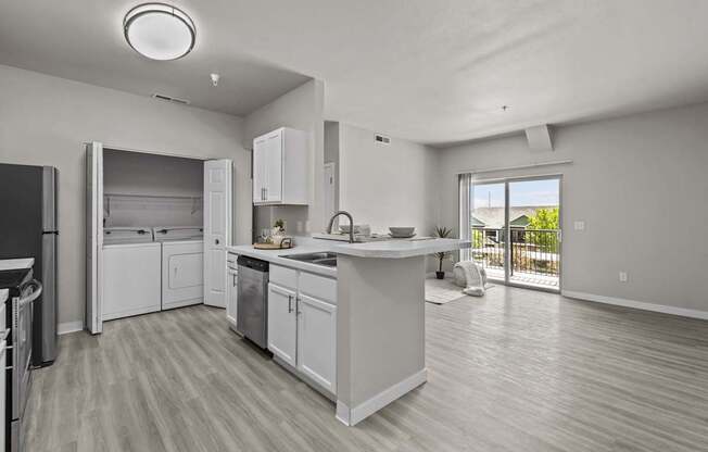A modern kitchen with white cabinets and appliances.