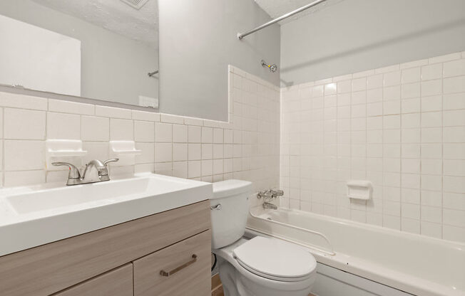 a bathroom with a sink toilet and a bath tub