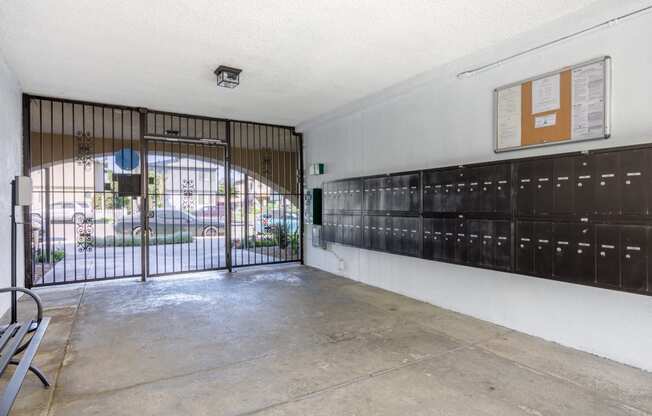 the entrance to a building with a gate and lockers