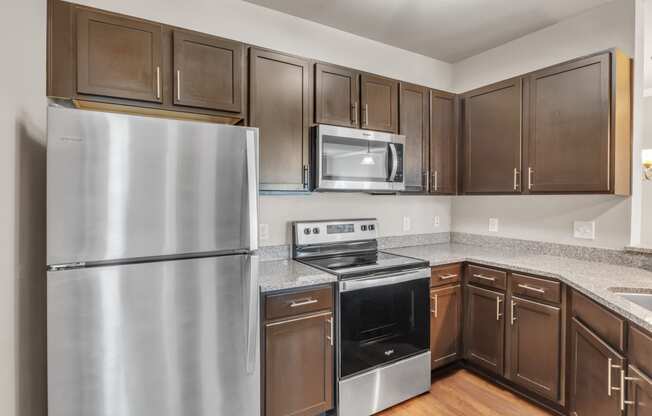 a kitchen with stainless steel appliances and granite counter tops