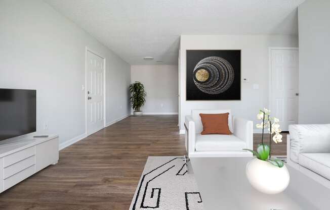 a living room with a white couch and a television