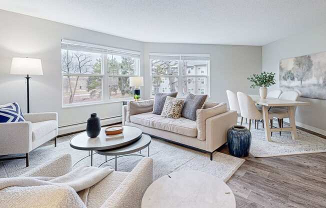 a living room with couches and chairs and a table