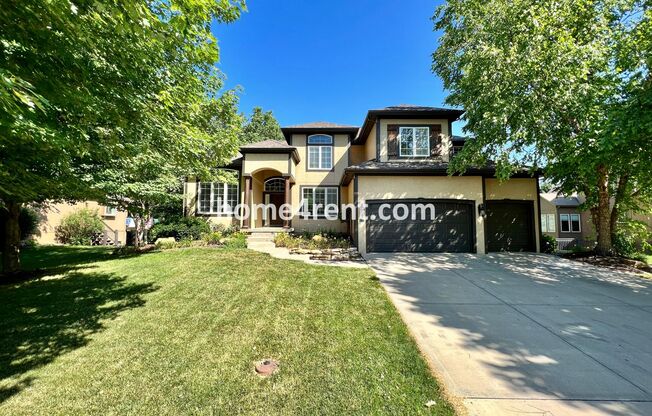 Blue Valley Schools, Wood Floors, Gourmet Kitchen, Finished Basement and a Fenced Yard!