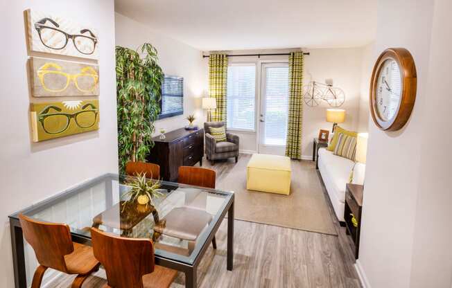 a living room with a glass table and a couch