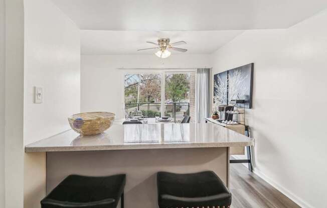 a kitchen with a counter top and a large window