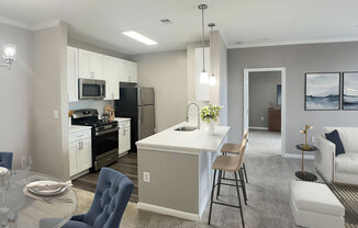 an open kitchen and living room with a table and chairs