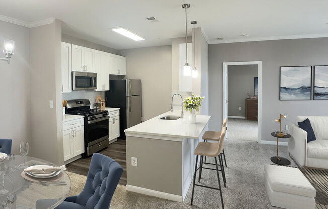 an open kitchen and living room with a table and chairs