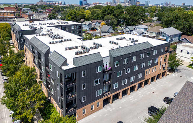 A large apartment complex with a parking lot in front.