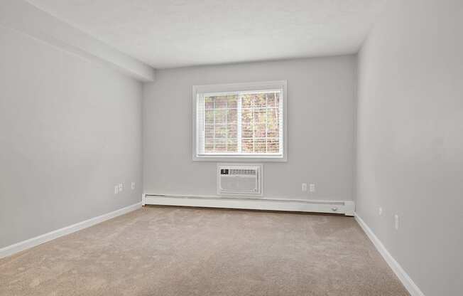 Empty room with a window and carpet  at the River, Manchester, 03102