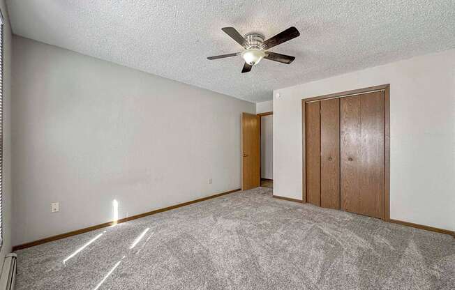an empty living room with a ceiling fan at Creekstone Falls, Sioux Falls, SD, 57106