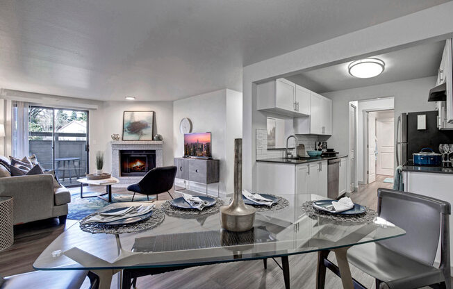 a living room with a glass table and chairs