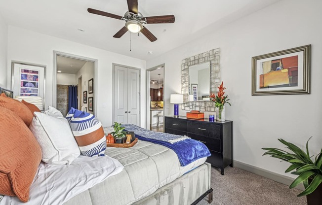 Cozy bedroom with a ceiling fan and contemporary decor at Allusion at West University apartments in Houston, TX