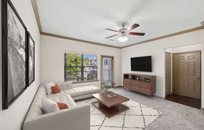 A living room with a white couch and a brown coffee table.