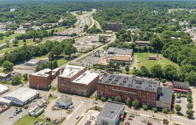 an aerial view of a city with buildings and trees at Mayton Transfer Lofts, Petersburg, VA 23803