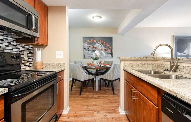 the kitchen and dining area of a home with a table and chairs