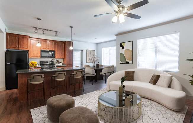 a living room and kitchen with wood cabinets and a white couch