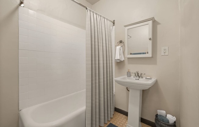 a small bathroom with a shower and a sink at Del Mor Apartments, California