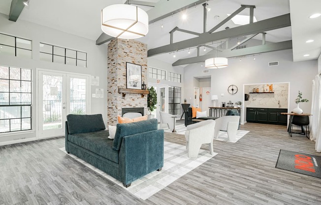 a living room with couches and chairs and a fireplace