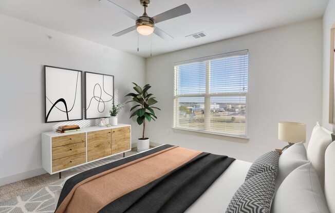 a bedroom with a large bed and a ceiling fan