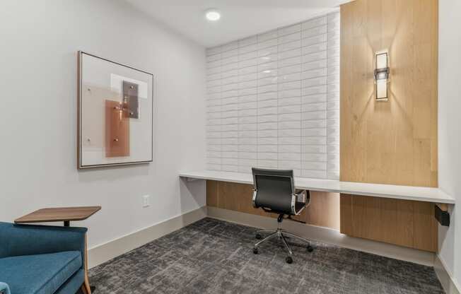 a small office area with a chair and a desk