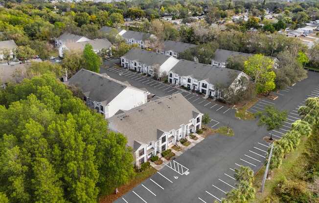 A parking lot with a white building in the background.