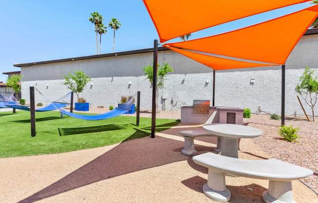 A playground with a blue slide and an orange canopy.
