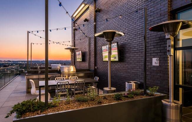 Rooftop seating area with entertainment and grill stations