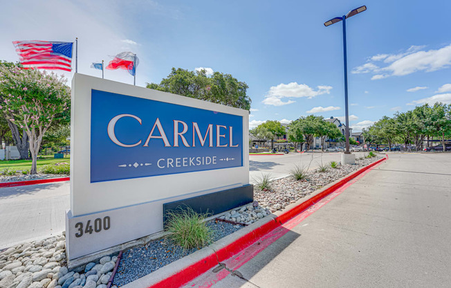 a sign for carmiel creek creekside in front of a parking lot