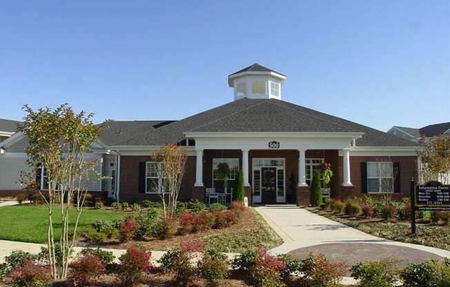 A building with a white cupola on top of it.