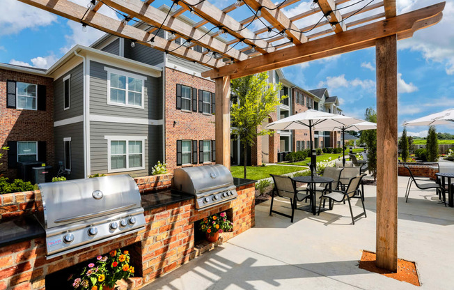 our apartments have a large patio with a grill and tables