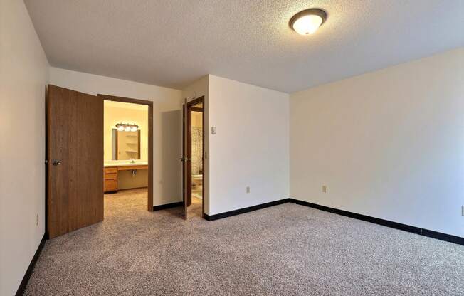 a bedroom with a bathroom attached. Fargo, ND Prairiewood Meadows