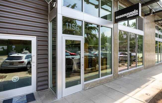 A car dealership with a white car displayed in the window.