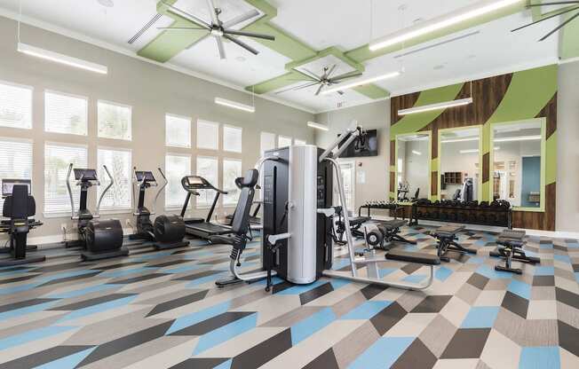 expansive fitness studio with weight tower and cardio machines