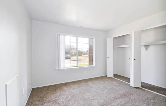 Comfortable bedroom with ample closet space at Farmbrooke Manor Apartments Clinton Township MI
